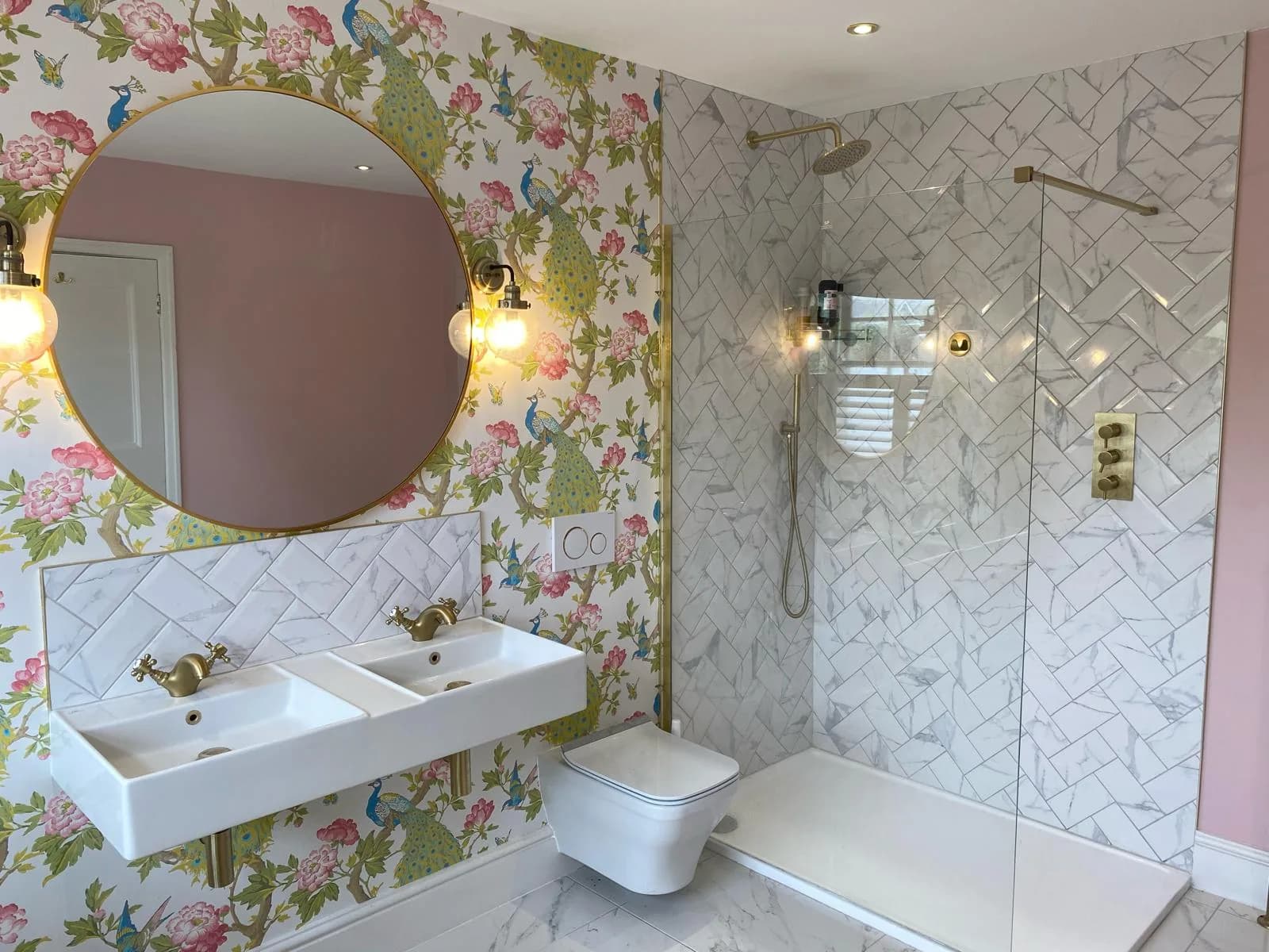 Peacock-wallpapered bathroom with a marble herringbone walk-in shower